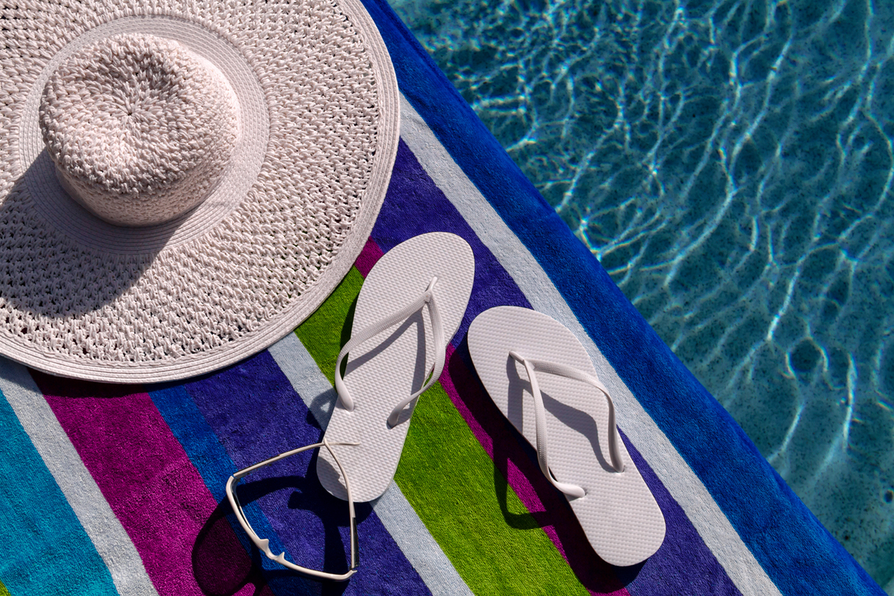 sandals, towel and hat by pool at Crescent Pointe located in the foothills of South Carolina